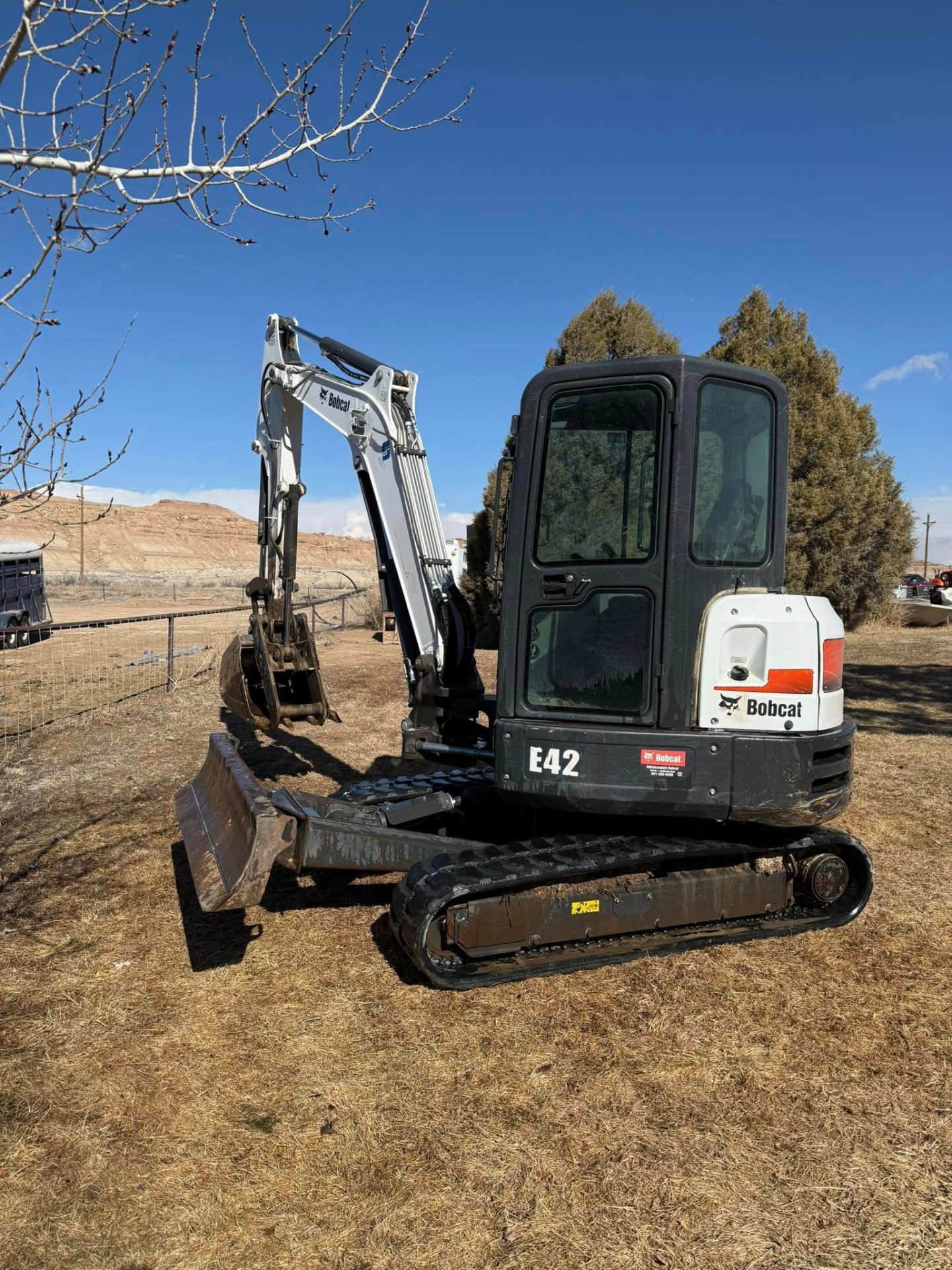 Outlaw Willy's Bobcat E42 mini excavator parked on a Uintah Basin property
